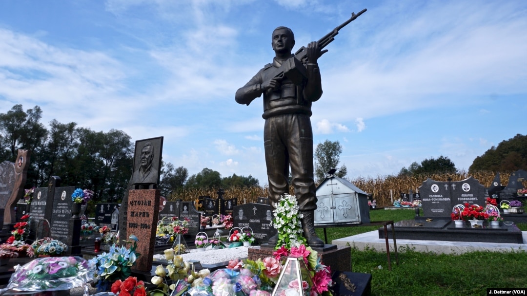 FILE - The grave of a Bosnian Serb soldier. All sides are meticulous in tending the graves of the dead from the Balkan wars of the 1990s that erupted as Yugoslavia fractured. 
