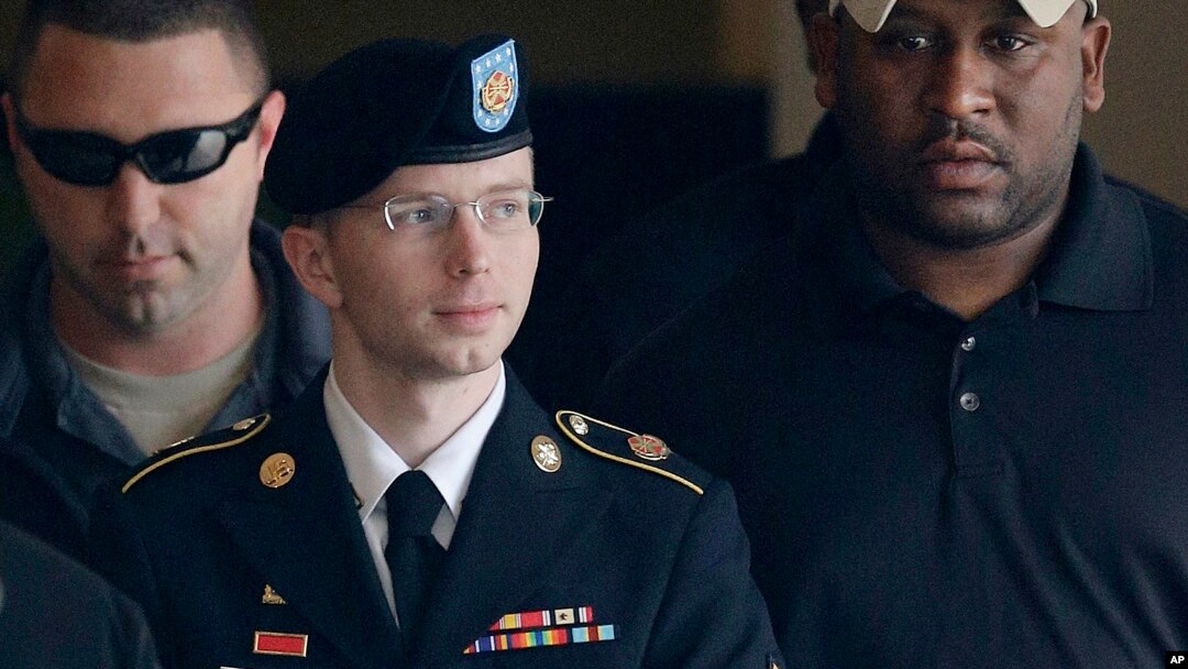 Army Pfc. Bradley Manning is escorted to a security vehicle outside a courthouse in Fort Meade, Maryland after a hearing in his court martial, August 20, 2013.