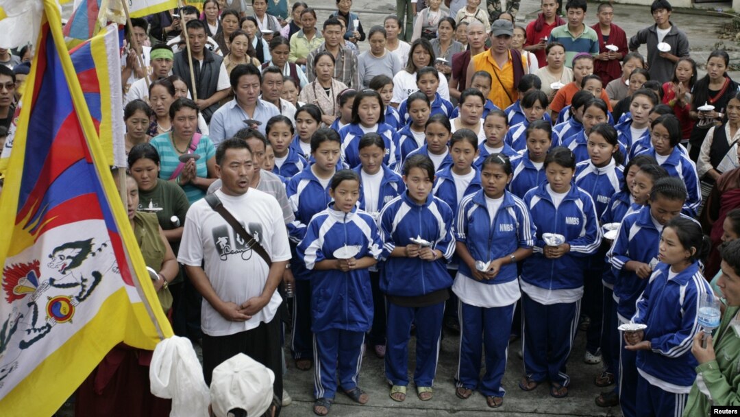 FILE - Exiled Tibetan school children sing their national anthem.