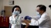 A medical worker receives a dose of the coronavirus disease (COVID-19) vaccine as the country launches its inoculation campaign, in Tokyo, Japan, Feb. 17, 2021.