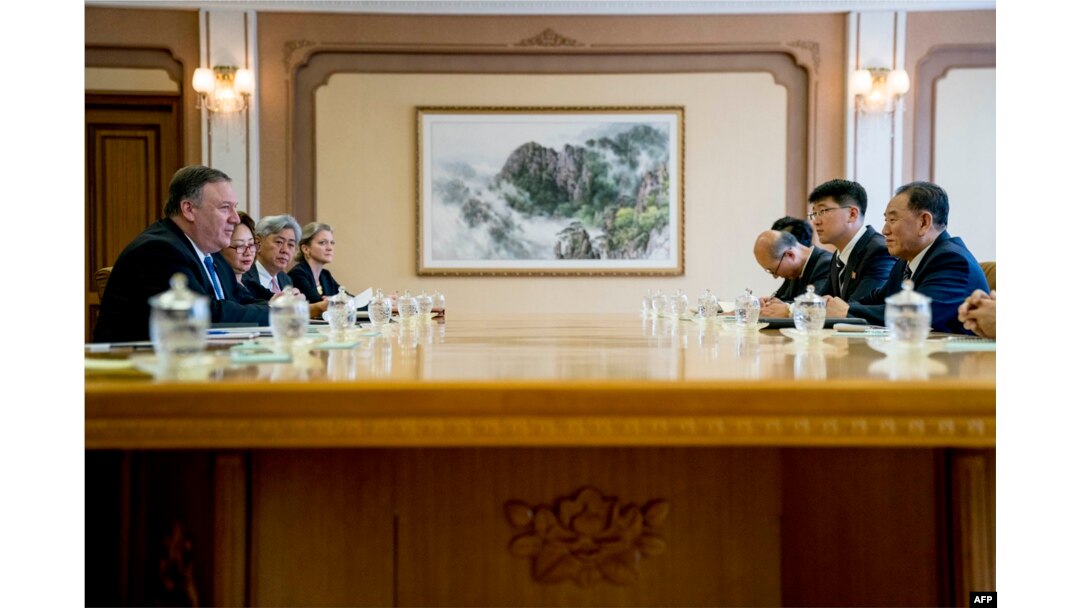 U.S. Secretary of State Mike Pompeo, left, speaks during a meeting with North Korea's director of the United Front Department, Kim Yong Chol, right, at the Park Hwa Guest House in Pyongyang, July 6, 2018.