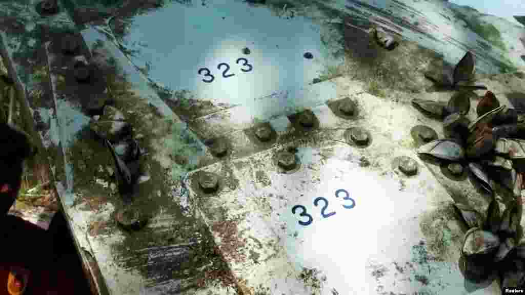 Details of a piece of suspected plane wreckage which has been found off the coast of southern Thailand is seen in Nakhon Si Thammarat province, Jan. 24, 2016.