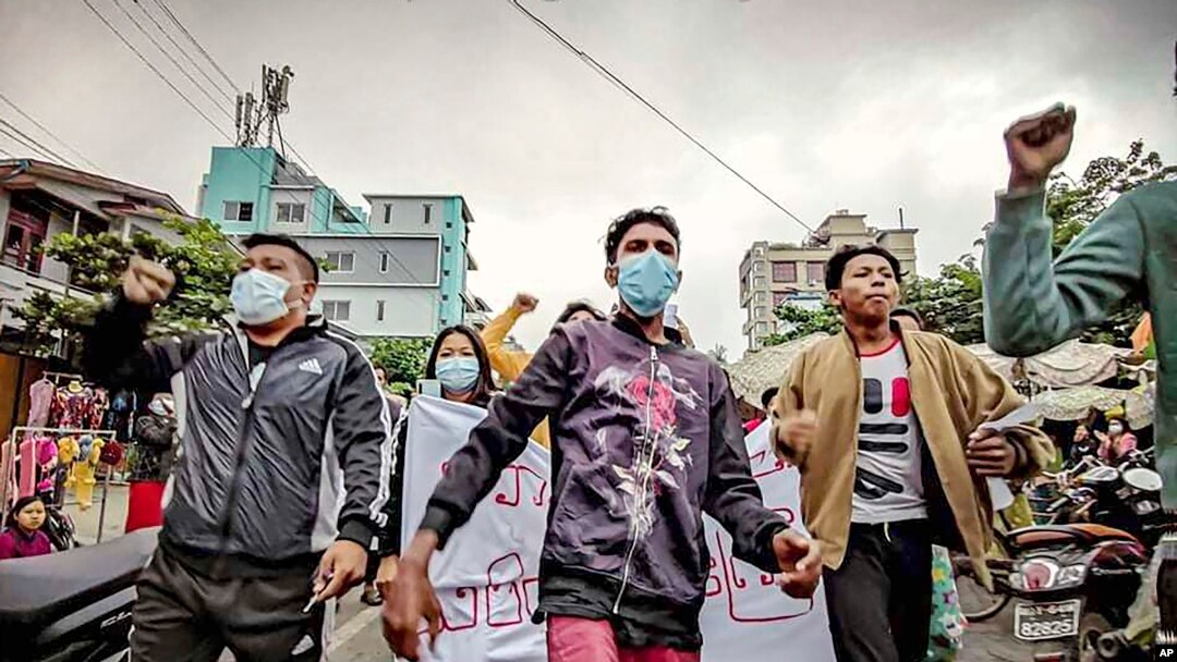 FILE - Protesters march through the streets during an anti-government demonstration in Mandalay, Myanmar, Dec. 7, 2021.