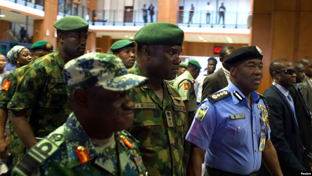 FILE: Nigerian mlitary officials are consulting with Sri Lanka on tactics that country used to overcome terrorists. Here, Nigerian Gen. Kenneth Minimah and guards leave a meeting in Abuja on May 15, 2014.