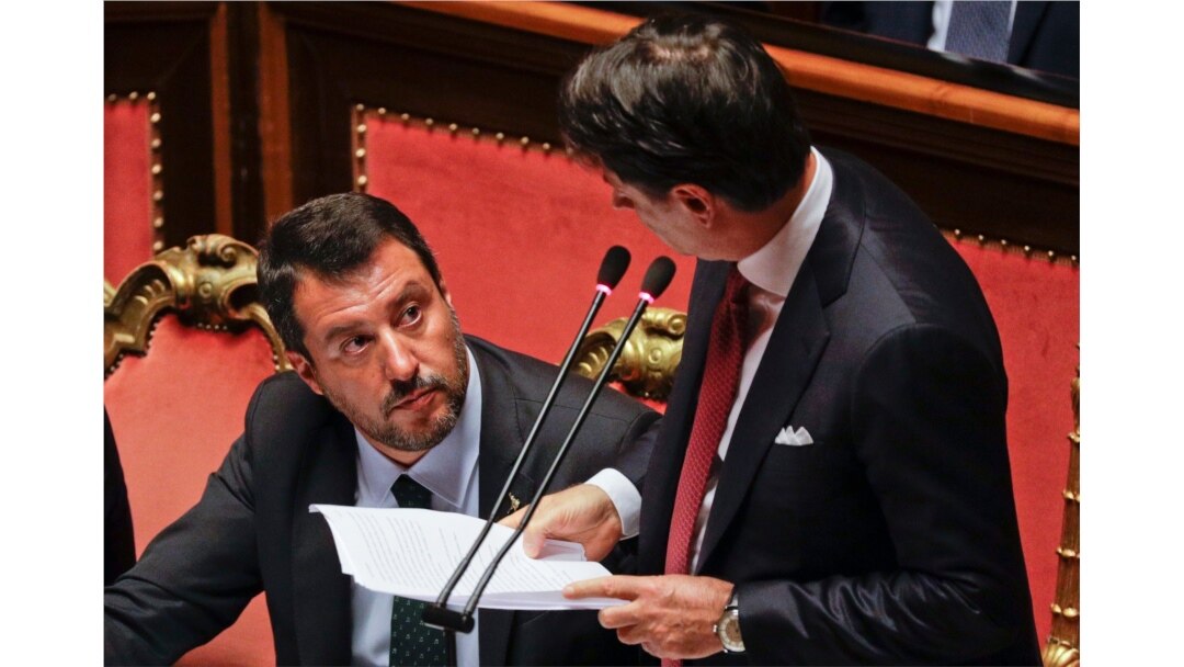 Italian Premier Giuseppe Conte, right, looks at Deputy-Premier Matteo Salvini who addresses the Senate in Rome, Aug. 20, 2019.