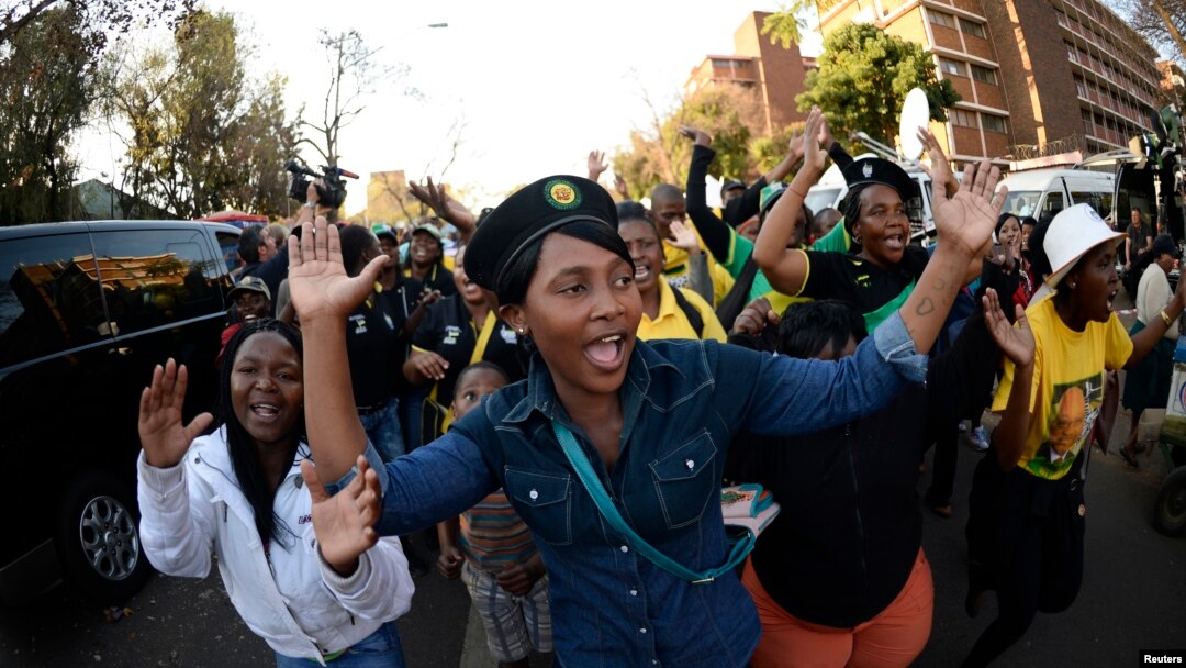 Mutane suna waka suna girmama Nelson Mandela yayin da yake jinya