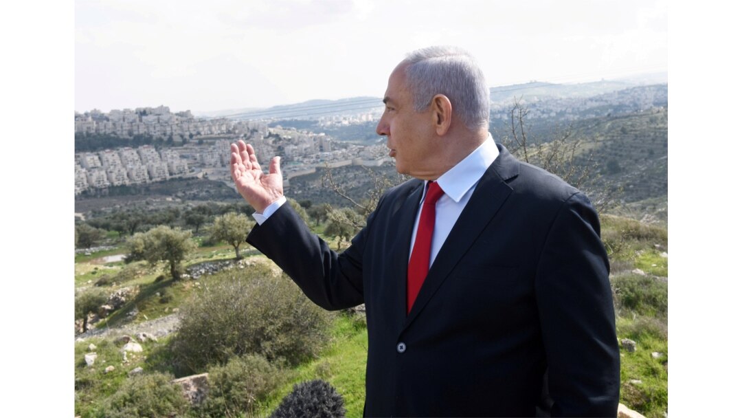 FILE - Prime Minister Netanyahu delivers a statement overlooking the Israeli settlement of Har Homa, in an area of Israeli-occupied West Bank, that Israel annexed to Jerusalem after the region's capture in 1967 Middle East war, Feb. 20, 2020.