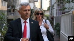 A U.S. embassy official escorts Norine Brunson, the wife of U.S. pastor Andrew Brunson, before his trial in Izmir, Turkey, early Oct. 12, 2018.