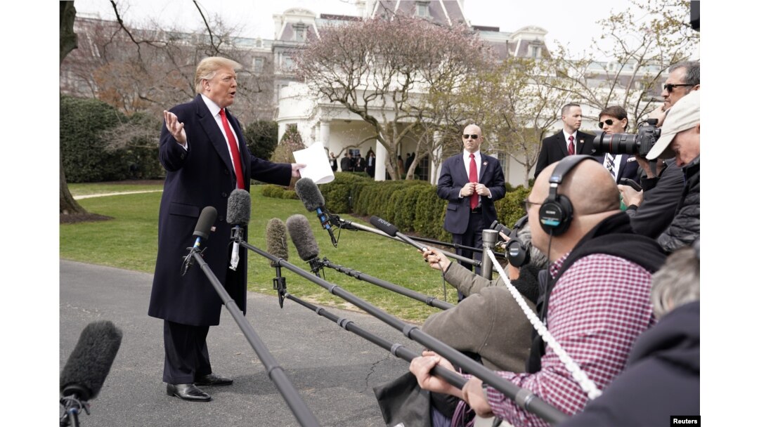 President Donald Trump talks to reporters as he departs on travel to Ohio from the White House in Washington, March 20, 2019.