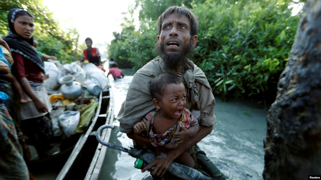 FILE - Rohingya refugees arrive to the Bangladeshi side of the Naf River after crossing the border from Myanmar, in Palang Khali, Bangladesh, Oct. 16, 2017. 