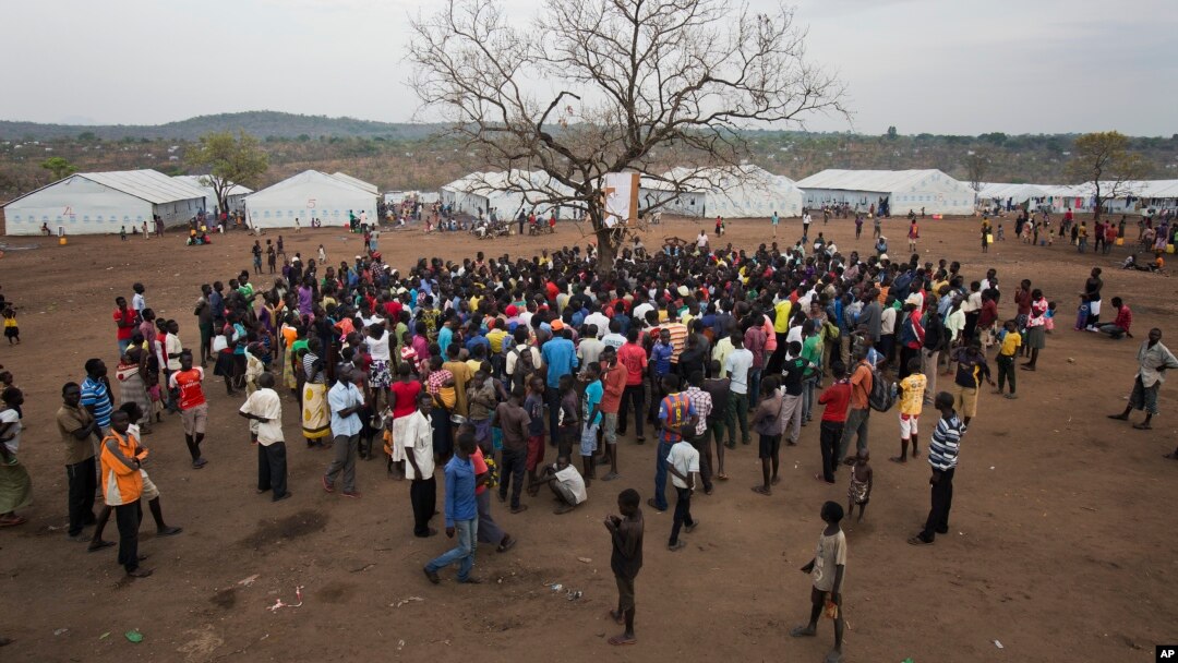 South Sudanese refugees at the Imvepi camp in Uganda gather under a tree. The civil war in South Sudan has killed tens of thousands and driven many thousands from their homes. (AP Photo/Jerome Delay) 