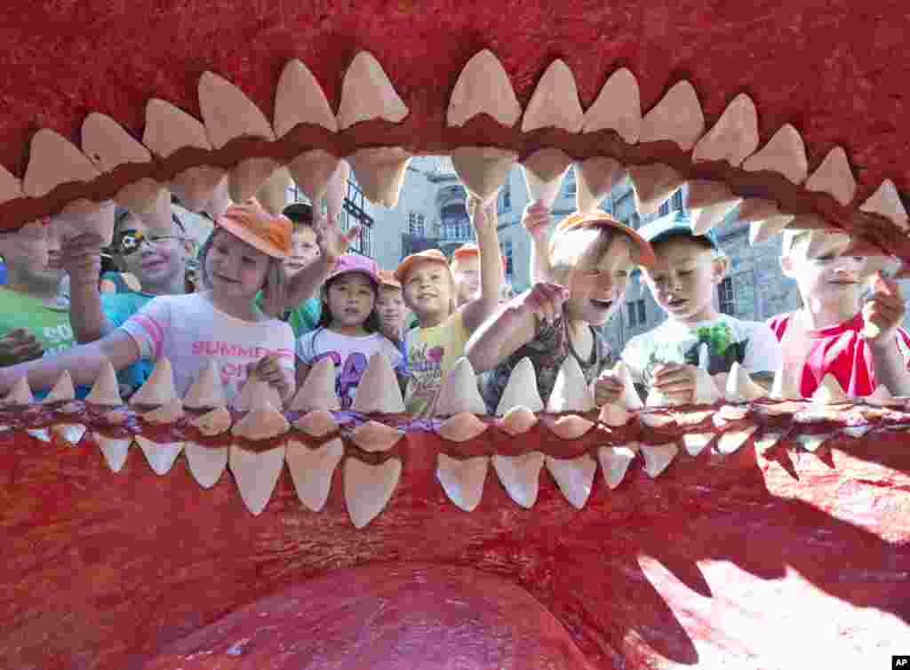 Children of a kindergarten admire the giant mouth of a primeval Megalodon shark model at the Natural History Museum in Schleusingen, central Germany.