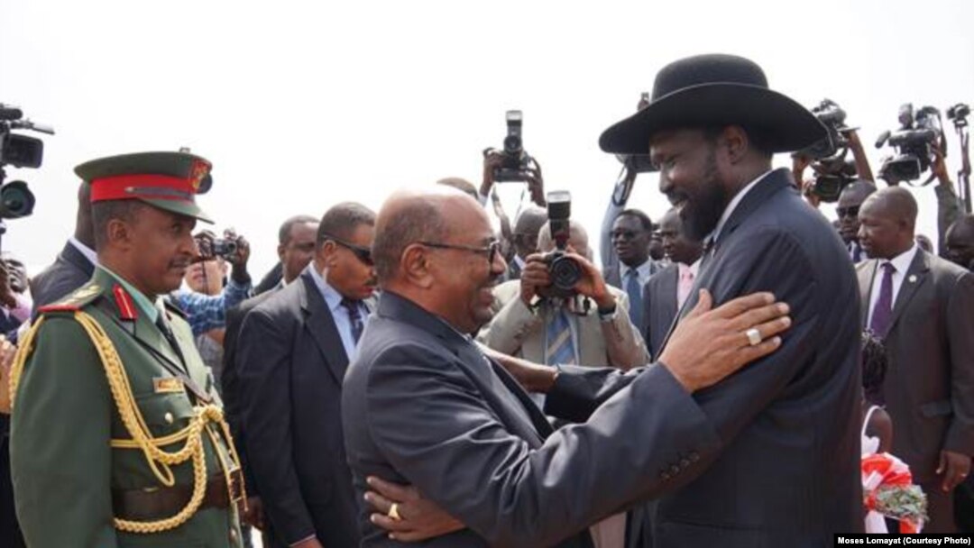 South Sudanese President Salva Kiir (r.) hugs his Sudanese counterpart Omar al Bashir on his arrival at Juba airport on Friday, April 12, 2013. The Sudanese president was visiting South Sudan for the first time since it split from Sudan in 2011.