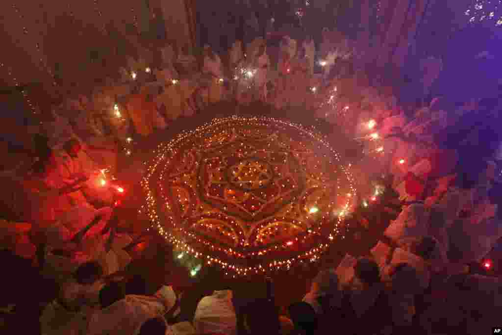 Indian widows light fireworks as they celebrate Diwali or the festival of lights at an Ashram in Vrindavan, India, Nov. 2, 2013.