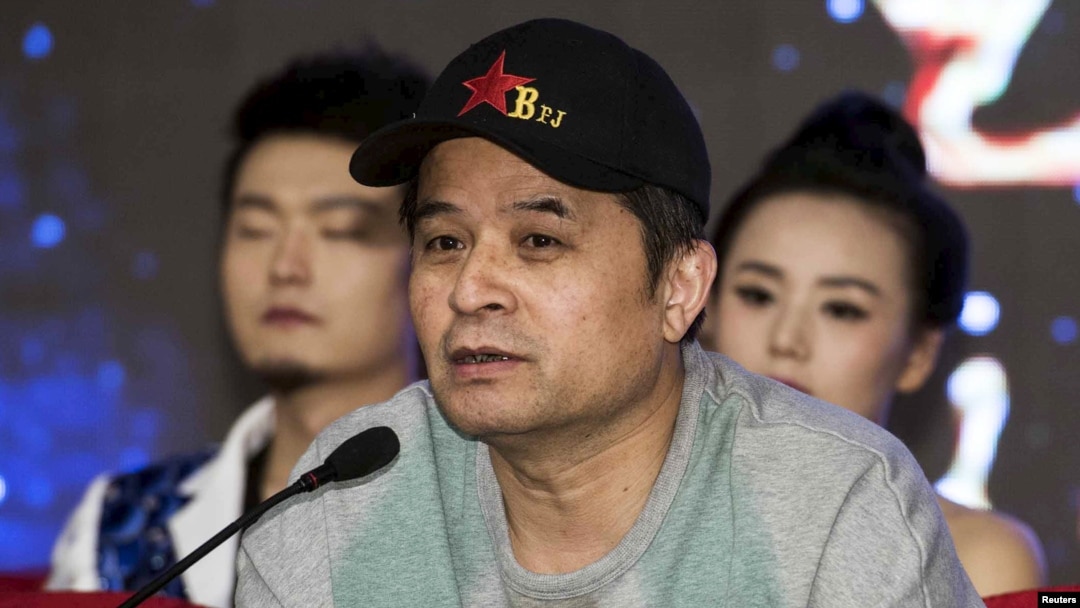 FILE - Bi Fujian, an anchor of China Central Television (CCTV), speaks during a news conference in Beijing.