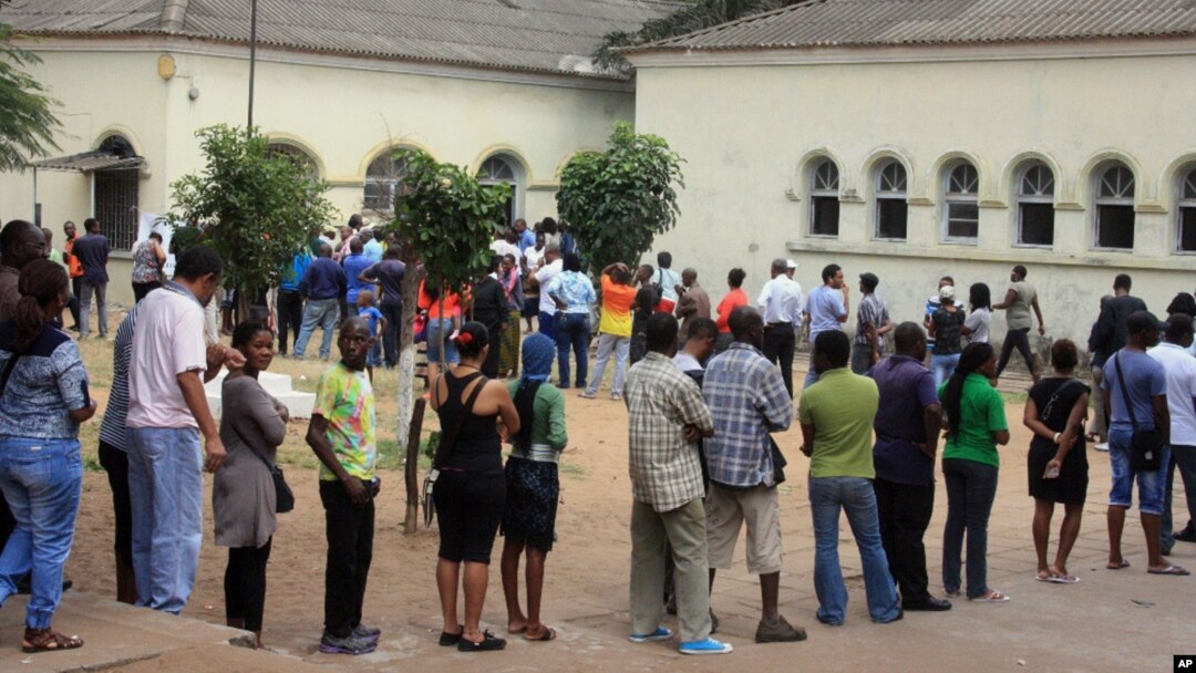FILE - Voters line up to cast their votes at a polling station, in Maputo, Mozambique, Oct. 15, 2014.