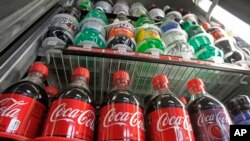 FILE - Sugar-sweetened drinks in a store's refrigerator, Feb. 20, 2013