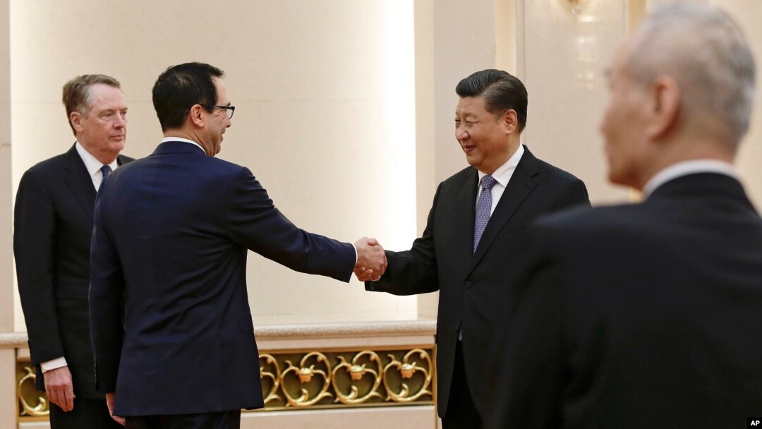 U.S. Treasury Secretary Steven Mnuchin, second from left, shakes hands with Chinese President Xi Jinping as U.S. Trade Representative Robert Lighthizer, left, and Chinese Vice Premier Liu He, right, look on before their meeting at the Great Hall of the Pe