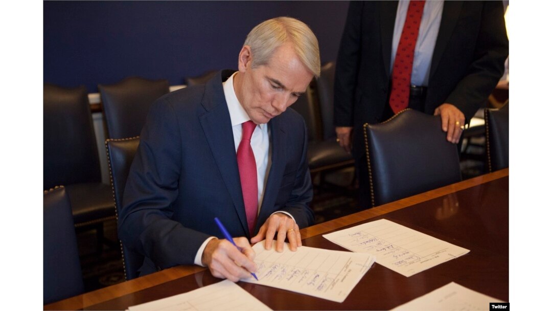 El senador Rob Portman, republicano por Ohio, firma el Reporte de la Conferencia de las dos Cámaras del Congreso de EE.UU. sobre la Ley de Recorte Impositivo y Empleos. Dic. 15, 2017. Foto: @senrobportman.