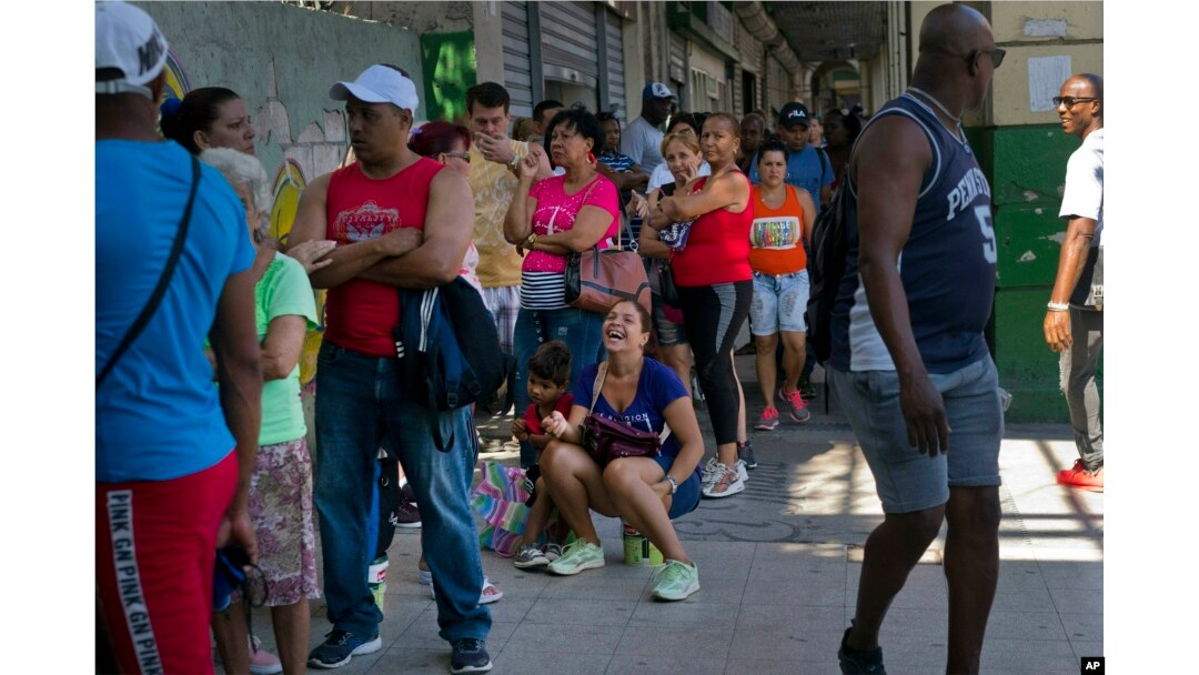 People wait in line to buy chicken at a government-run grocery store in Havana, Cuba, April 17, 2019.