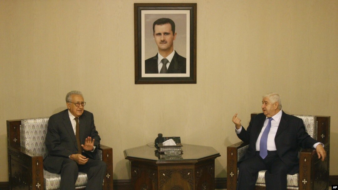 Lakhdar Brahimi, the U.N.-Arab League envoy to Syria, left, meets with Syrian Foreign Minister Walid Moallem, right, in Damascus, Syria, September 13, 2012.