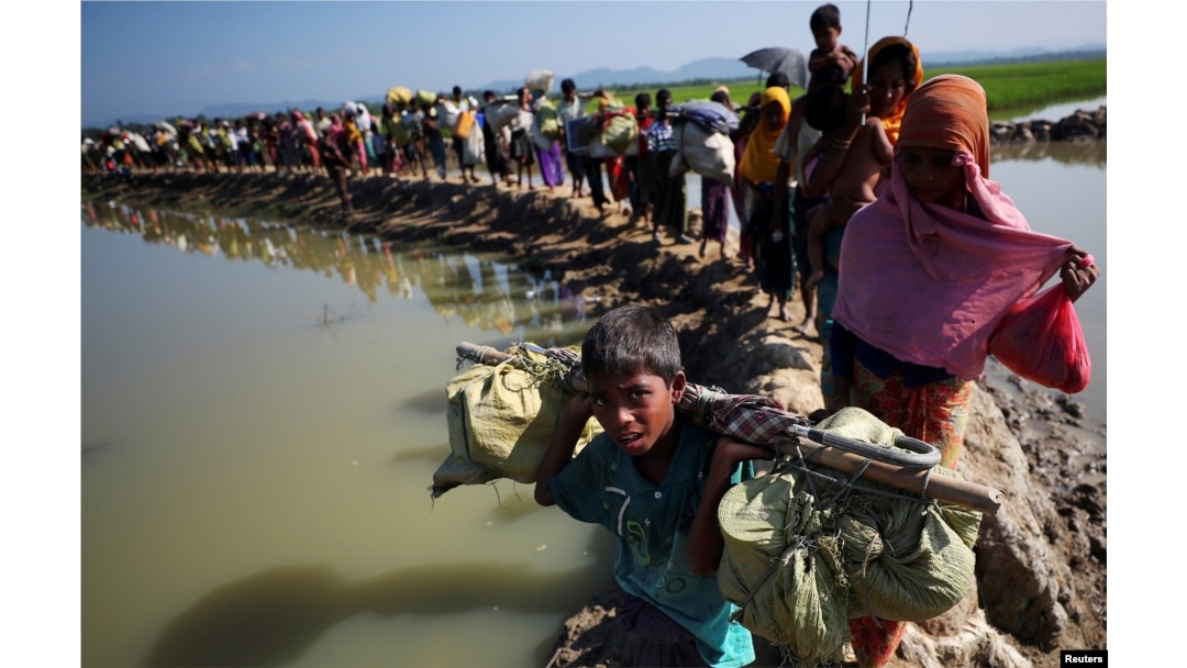 Rohingya refugees make their way to a refugee camp after crossing the Bangladesh-Myanmar border in Palong Khali, near Cox's Bazar, Bangladesh, Nov. 3, 2017.