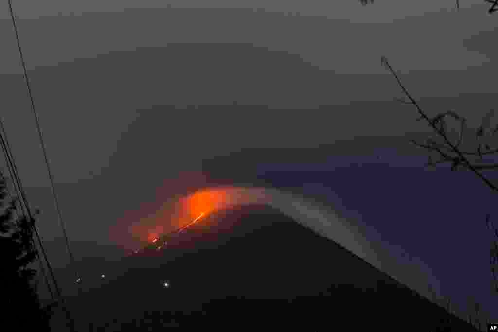 Pacaya volcano spews lava, viewed from San Vicente Pacaya, Guatemala.