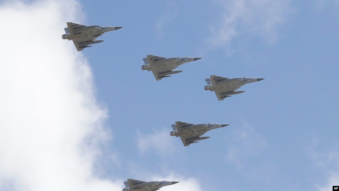 FILE - Taiwan's Mirage 2000 fighter jets fly in close formation over President Office during National Day celebrations in front of the Presidential Building in Taipei, Oct. 10, 2021.