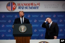 President Donald Trump speaks as Sec of State Mike Pompeo looks on during a news conference after a summit with North Korean leader Kim Jong Un, Thursday, Feb. 28, 2019, in Hanoi. (AP Photo/ Evan Vucci)