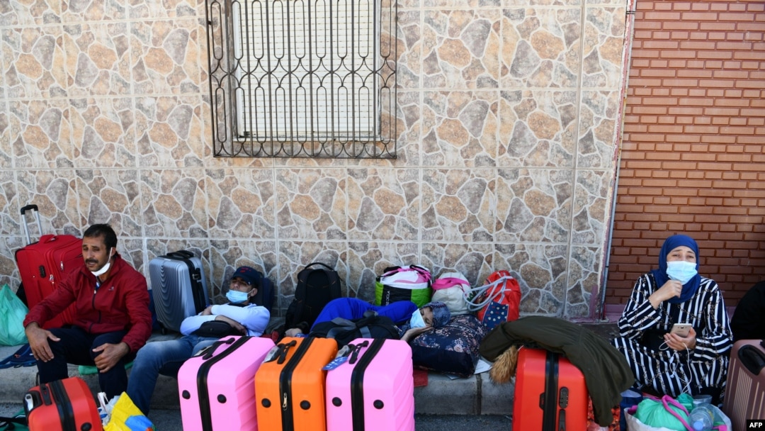 FILE - Moroccan citizens wait for their repatriation after being stranded in Spain due to the coronavirus crisis, on May 22, 2020, in the Spanish enclave of Ceuta. 