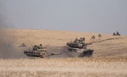 Turkish tanks and troops are stationed near Syrian town of Manbij, Syria, Oct. 15, 2019.
