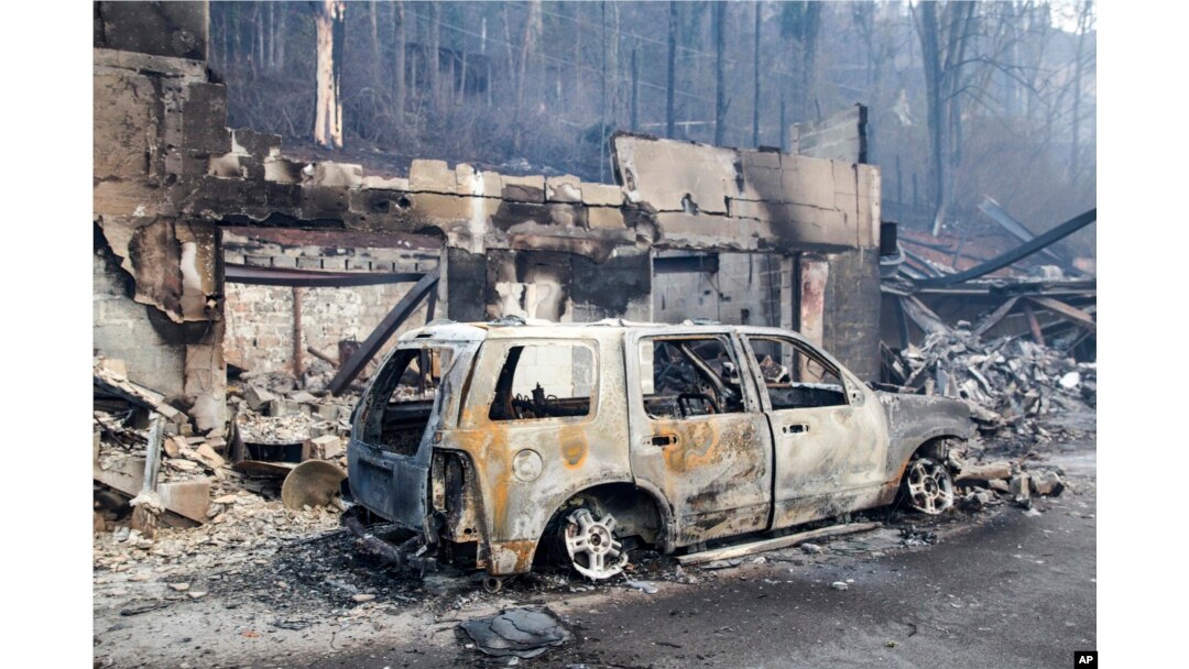 A scorched vehicle sits next to a burned-out building in Gatlinburg, Tennessee, Nov. 29, 2016.