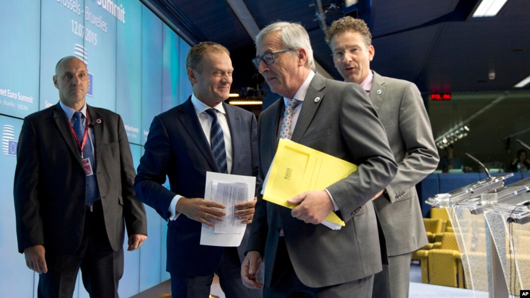 FILE - European Council President Donald Tusk (2nd l), European Commission President Jean-Claude Juncker and Dutch Finance Minister Jeroen Dijsselbloem speak with each other during a media conference after a meeting of eurozone heads of state, July 13, 2015.