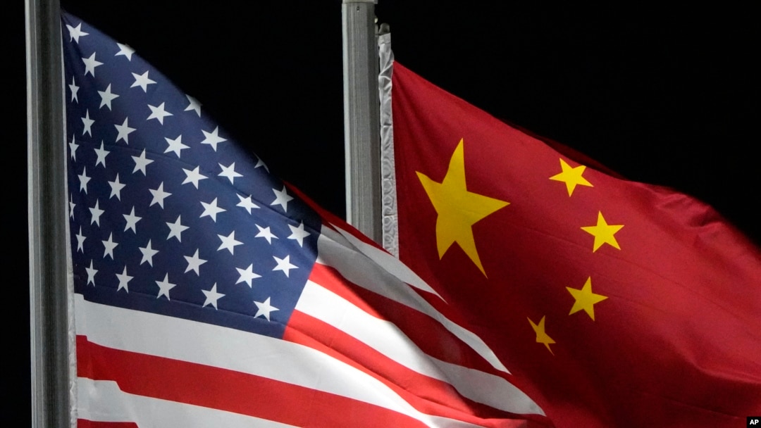 FILE - The American and Chinese flags wave ahead of the 2022 Winter Olympics, Feb. 2, 2022, in Zhangjiakou, China. 