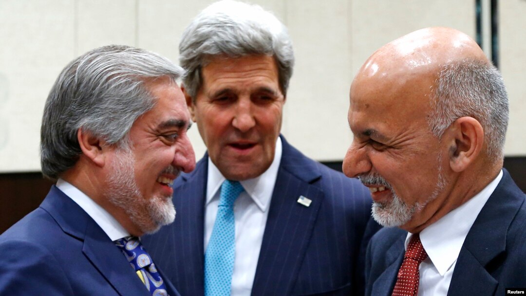 With U.S. Secretary of State John Kerry (C) watching, Afghanistan President Mohammad Ashraf Ghani (R) talks with Afghan Chief Executive Abdullah Abdullah at a NATO foreign ministers meeting in Brussels, Dec. 2, 2014.