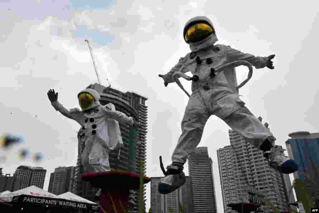 Models dressed as astronauts jump during a selection process, dubbed Apollo national challenge, at a park in Manila, Philippines. The selection was trimmed from around 28,000 applicants to 400, where the best two were selected. In December, the winners will be sent to Axe Apollo space camp in the U.S. for astronaut training, along with over a hundred other candidates from all over the world.