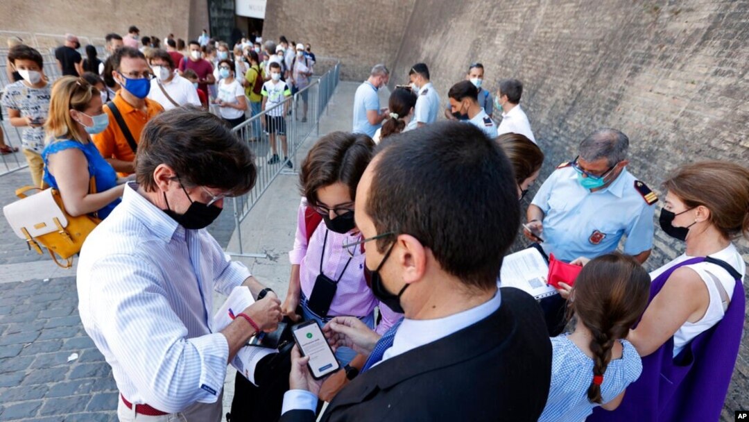 Tourists have their Green Pass checked by keepers at the entrance of the Vatican Museums, Aug. 6, 2021. 