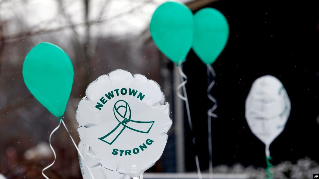 FILE - Balloons are displayed outside a doctor's office on the first anniversary of the Sandy Hook massacre, in Newtown, Connecticut, Dec. 14, 2013. 