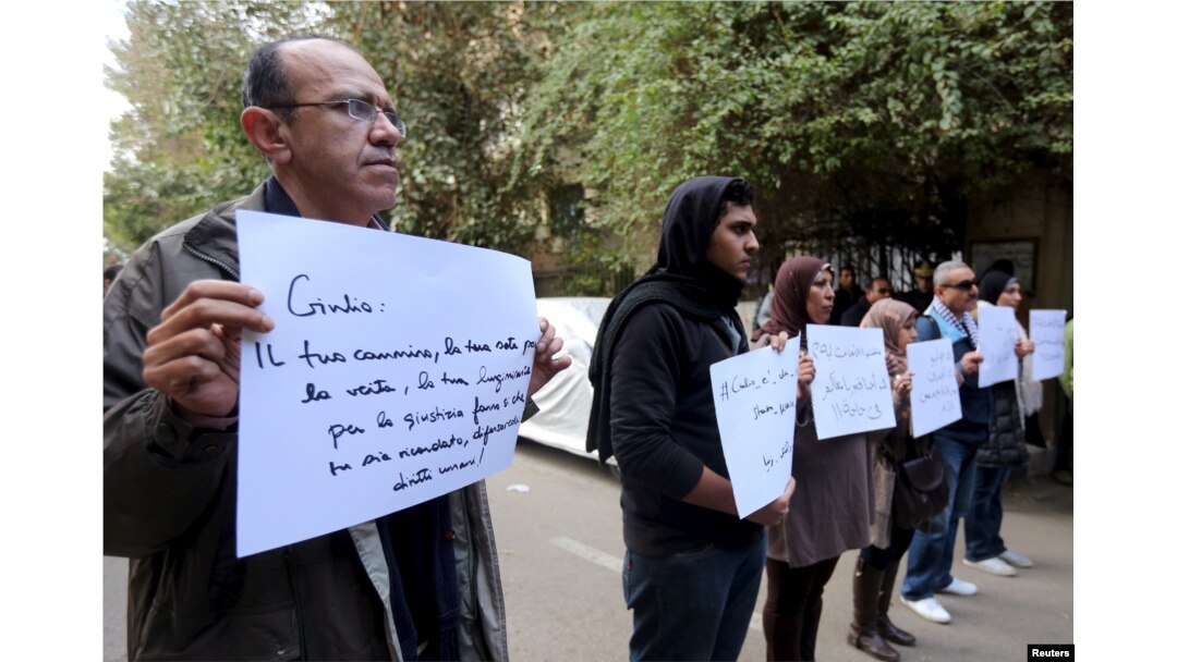 Activists hold placards that read, among others, "Giulio, one of us and killed like us," during a memorial for Giulio Regeni outside of the Italian embassy in Cairo, Egypt, Feb. 6, 2016.
