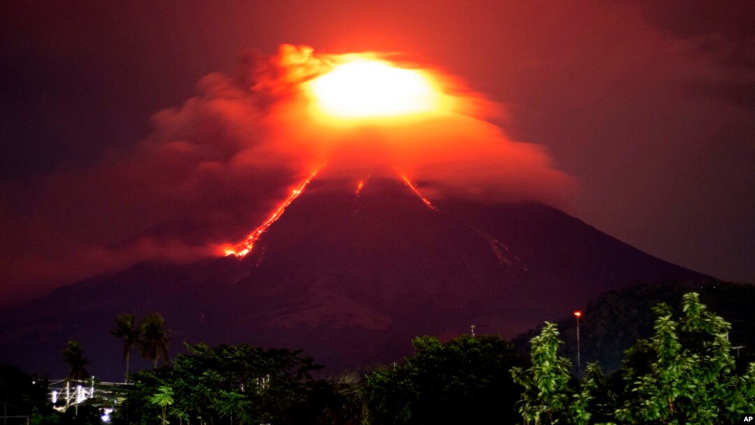 Lava cascades down the slopes of Mayon volcano as seen from Legazpi city, Albay province, around 340 kilometers (210 miles) southeast of Manila, Philippines, Jan. 15, 2018.