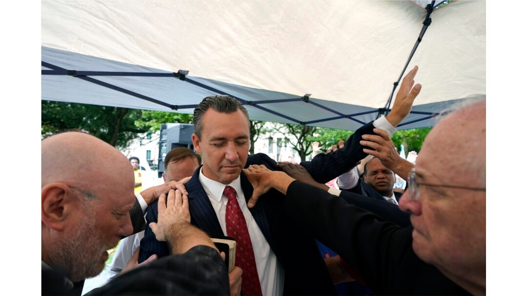 FILE - In this June 7, 2021 file photo, Tony Spell, pastor of the Life Tabernacle Church of Central City, La., prays with supporters outside the Fifth Circuit Court of Appeals in New Orleans.