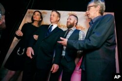 FILE - CSI: NY cast members, from left, Sela Ward, Gary Sinise, second from left, A.J. Buckley, and Robert Joy, right, wait to have their group photograph taken with guests of the gala marking the 10th anniversary of Hope Village for Children.