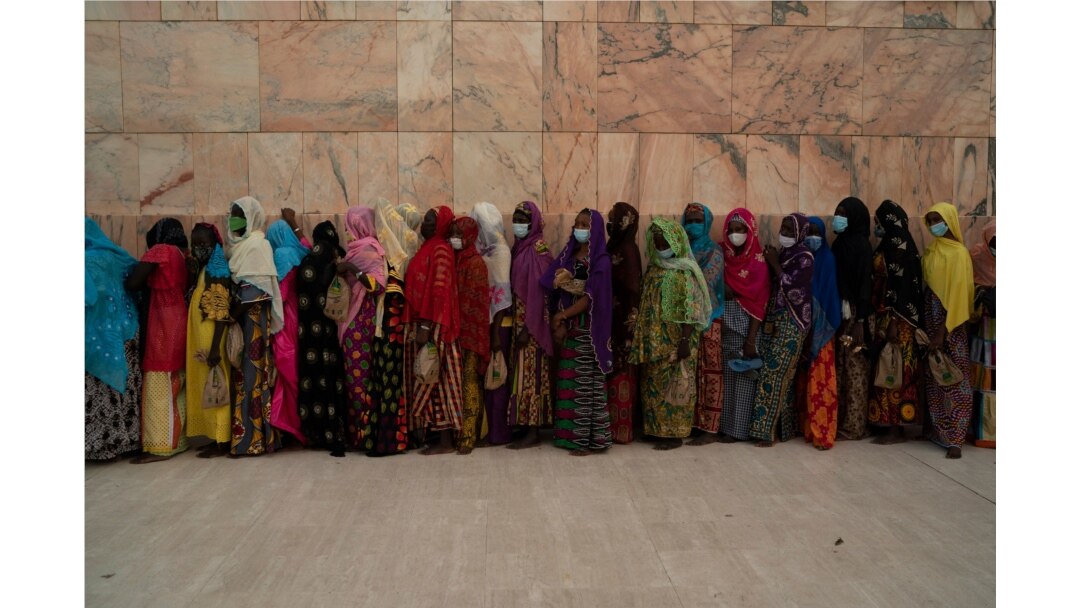 Wearing protective masks, women stand in line to enter the Grand Mosque of Touba as they take part in the celebrations of the Grand Magal of Touba, Senegal, Oct. 5, 2020.