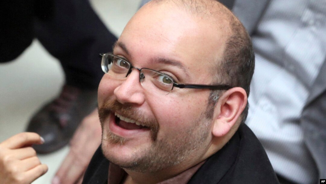FILE - Jason Rezaian, an Iranian-American correspondent for the Washington Post smiles as he attends a presidential campaign of President Hassan Rouhani in Tehran, Iran.