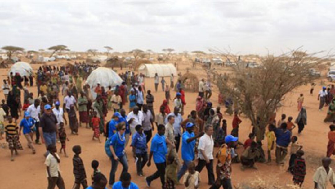 UN High Commissioner for Refugees Antonio Guterres, center right, in white shirt, walks with UNHCR staff and Somali refugees during a visit to Dagahaley Camp, near Dadaab, Kenya.