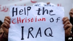 An Iraqi Christian who lives in Lebanon holds a placard during a sit-in, in front of the United Nations Headquarters demanding speeding up their immigration cases in Beirut, Lebanon, Feb. 13, 2017.