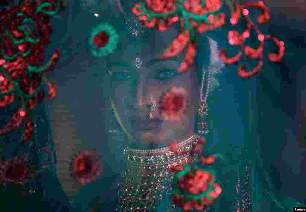 A transgender woman waits backstage to perform during an event to raise funds for the transgender community in Mumbai, India.