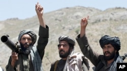 FILE - Taliban fighters react to a speech by their senior leader in the Shindand district of Herat province, Afghanistan. Taliban spokesman Zabihullah Mujahid said the group would be ready for peace talks with the United States, if their demands were met.