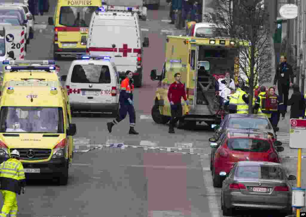 A woman is evacuated in an ambulance by emergency services after a explosion in a main metro station in Brussels, March 22, 2016.