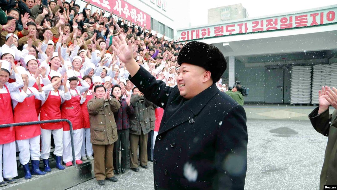 North Korean leader Kim Jong Un waves to workers during a visit to the Pyongyang Children's Foodstuff Factory in this undated photo released by North Korea's Korean Central News Agency (KCNA) in Pyongyang, Dec. 16, 2014. 